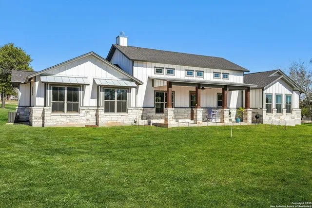 a front view of a house with swimming pool and sitting area