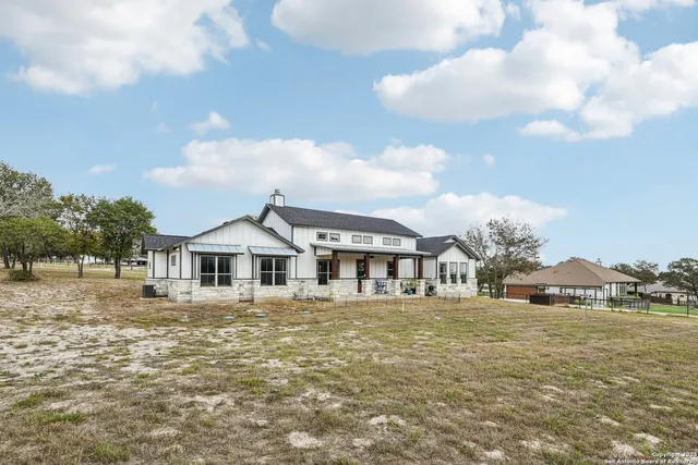a view of a field with trees in background