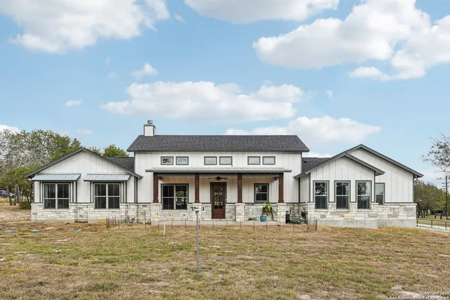 a view of a yard with a house in the background