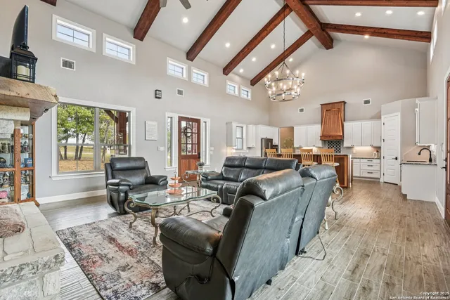 a living room with furniture a fireplace and a large window