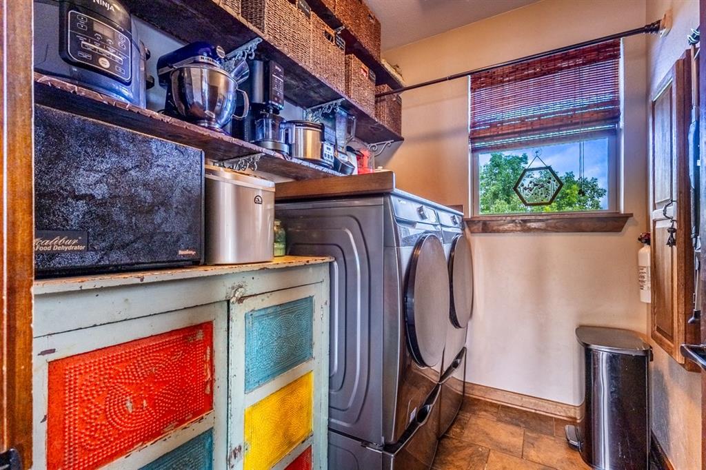 7060 Hells Gate Loop Strawn, TX 76475 - Photo 8 of 40 a utility room with a sink a washer and dryer