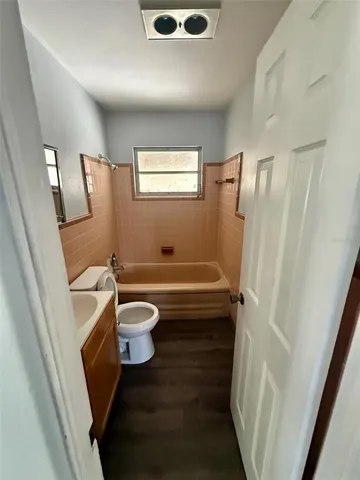 a bathroom with a toilet a sink and a mirror