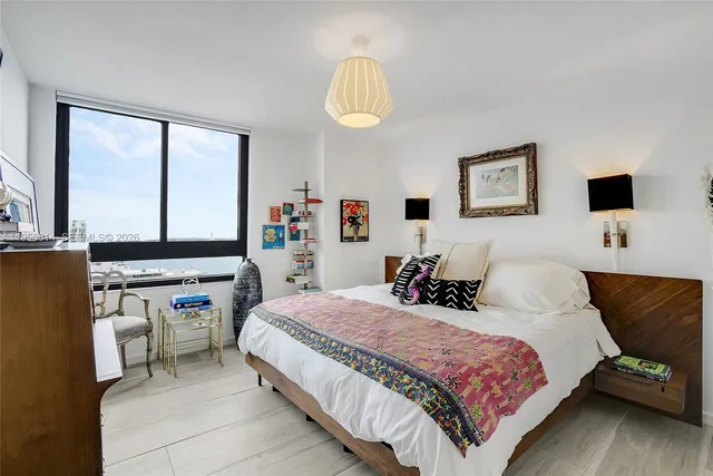 a bedroom with a bed and a chandelier