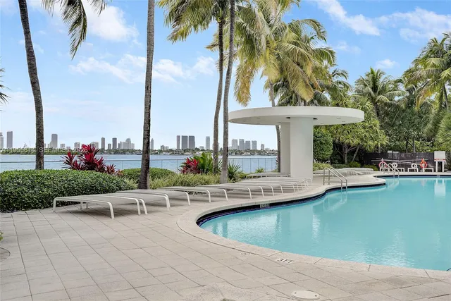 a view of a patio with swimming pool and table and chairs