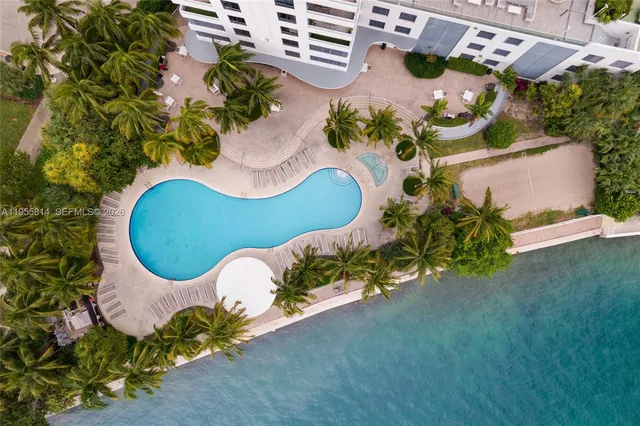 an aerial view of a house with a table and tennis court