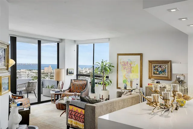 a living room with furniture large window and flat screen tv