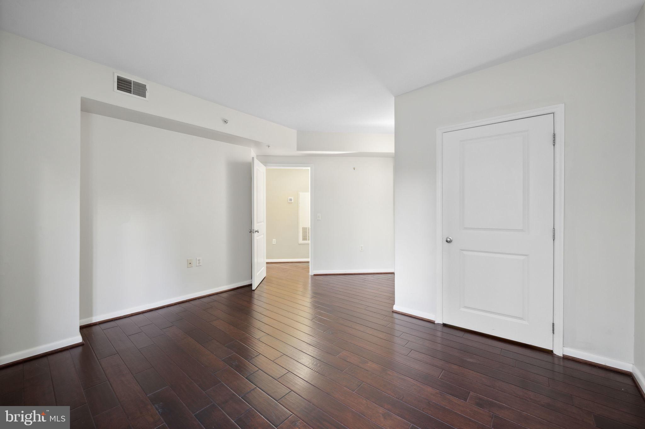 851 North Glebe Road, Unit 604 Arlington, VA 22203 - Photo 16 of 58 a view of an empty room with wooden floor