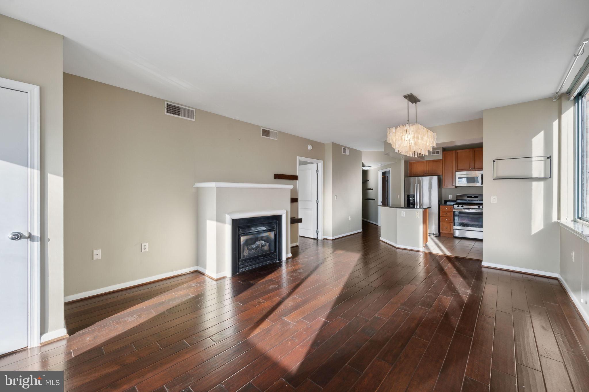 851 North Glebe Road, Unit 604 Arlington, VA 22203 - Photo 17 of 58 a view of a livingroom with wooden floor and a fireplace