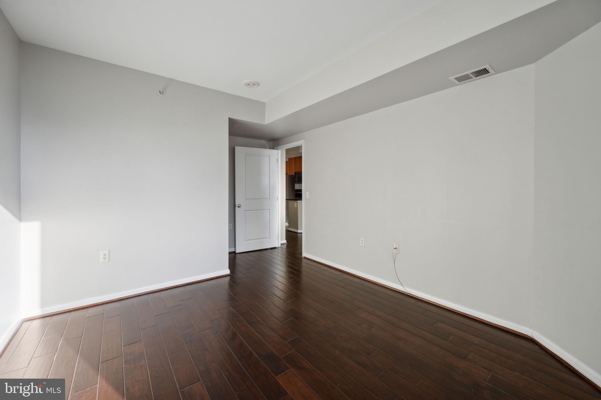 851 North Glebe Road, Unit 604 Arlington, VA 22203 - Photo 18 of 58 a view of an empty room with wooden floor