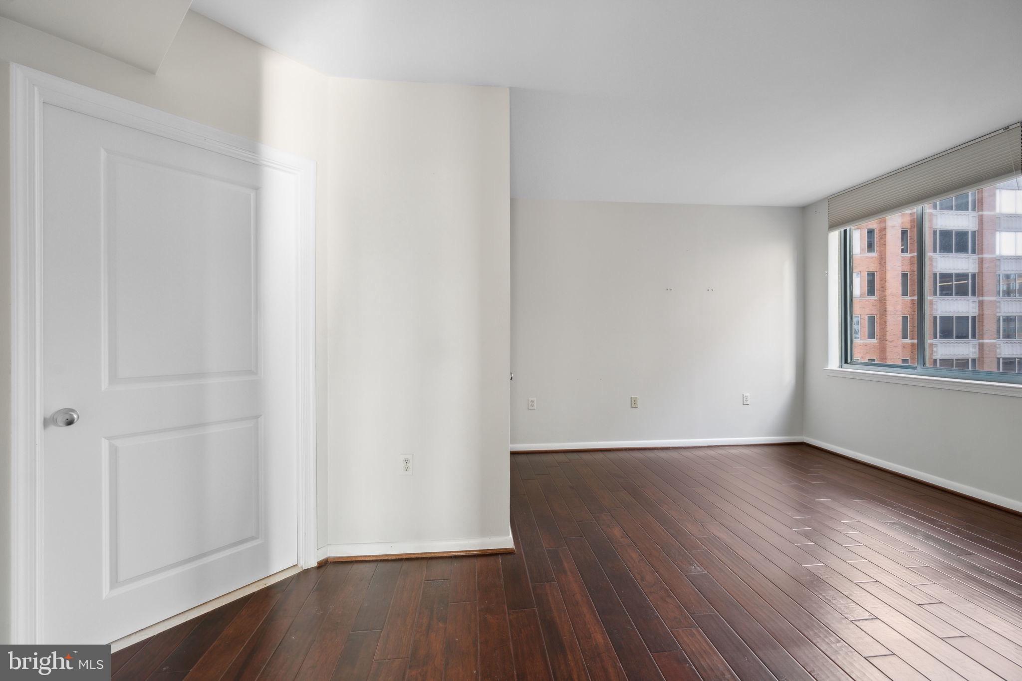 851 North Glebe Road, Unit 604 Arlington, VA 22203 - Photo 21 of 58 a view of an empty room with wooden floor and a window