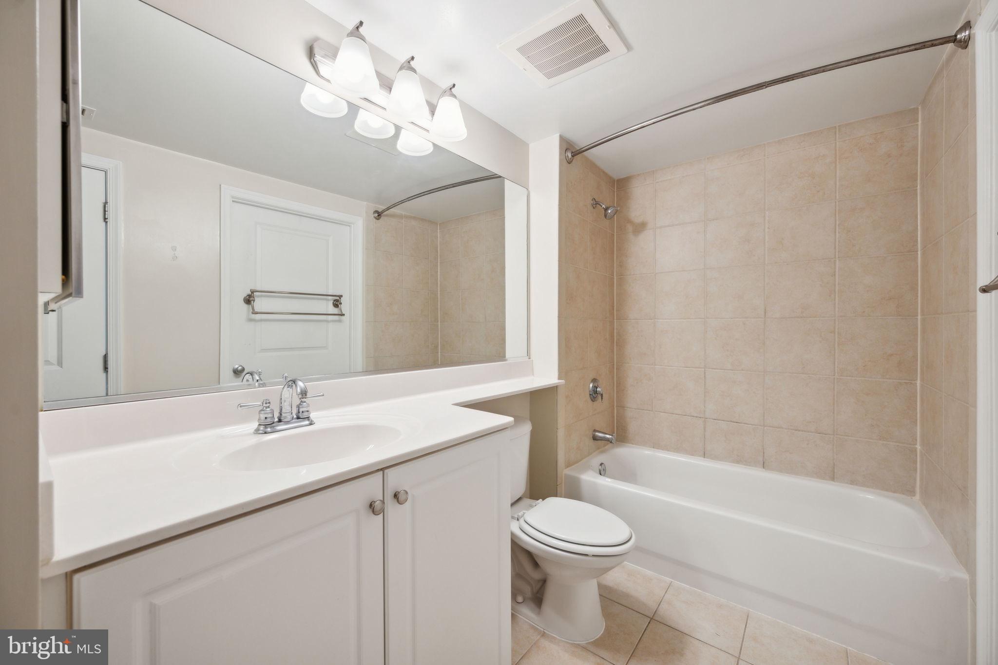 851 North Glebe Road, Unit 604 Arlington, VA 22203 - Photo 22 of 58 a bathroom with a sink a toilet a mirror and shower