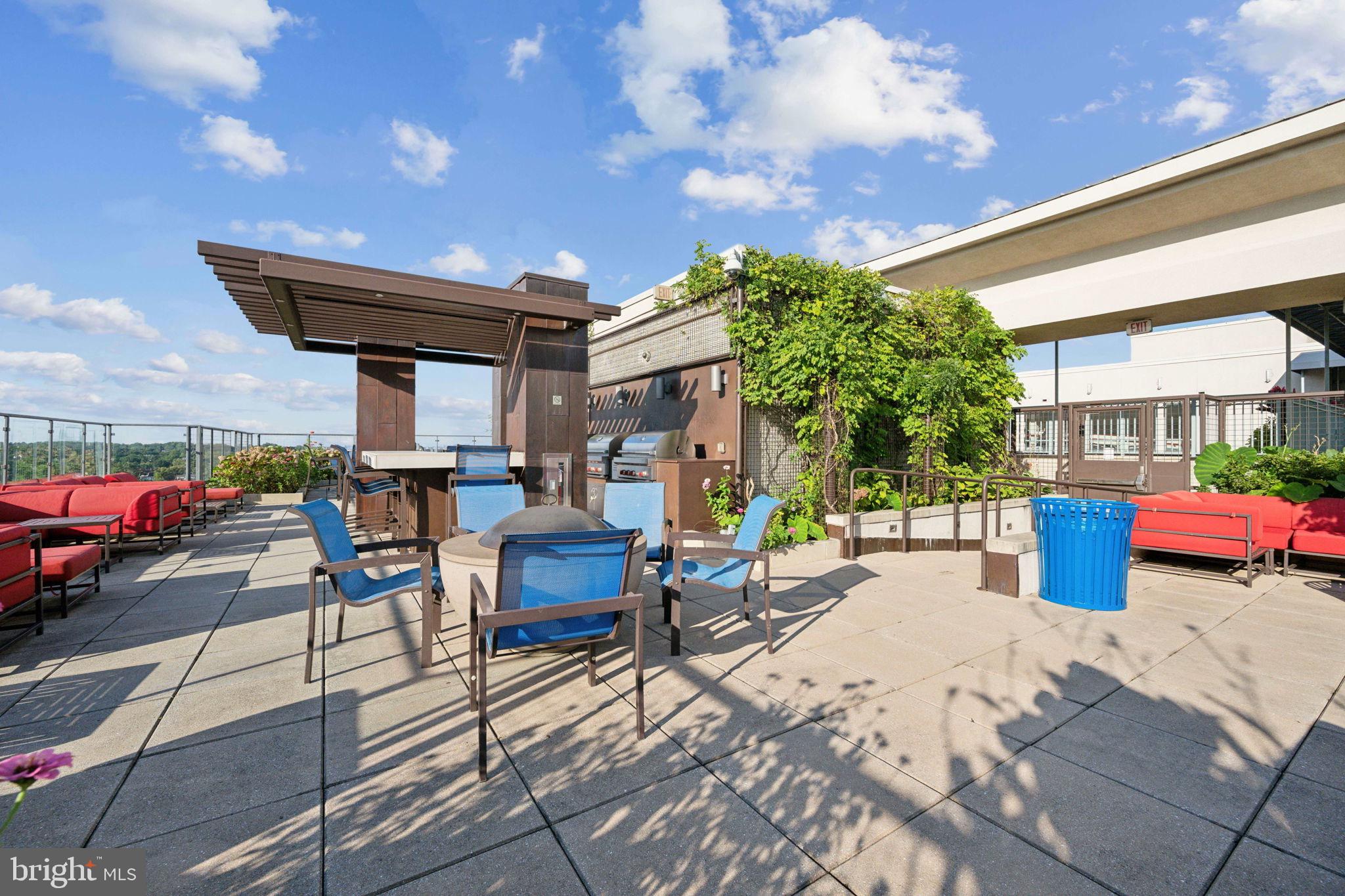851 North Glebe Road, Unit 604 Arlington, VA 22203 - Photo 31 of 58 a view of a patio with table and chairs potted plants with wooden fence