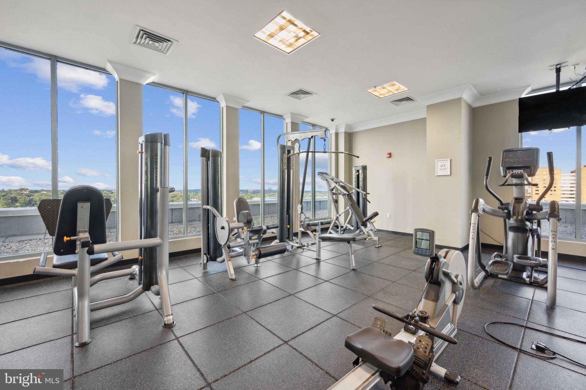 851 North Glebe Road, Unit 604 Arlington, VA 22203 - Photo 32 of 58 a room with gym equipment and large mirror