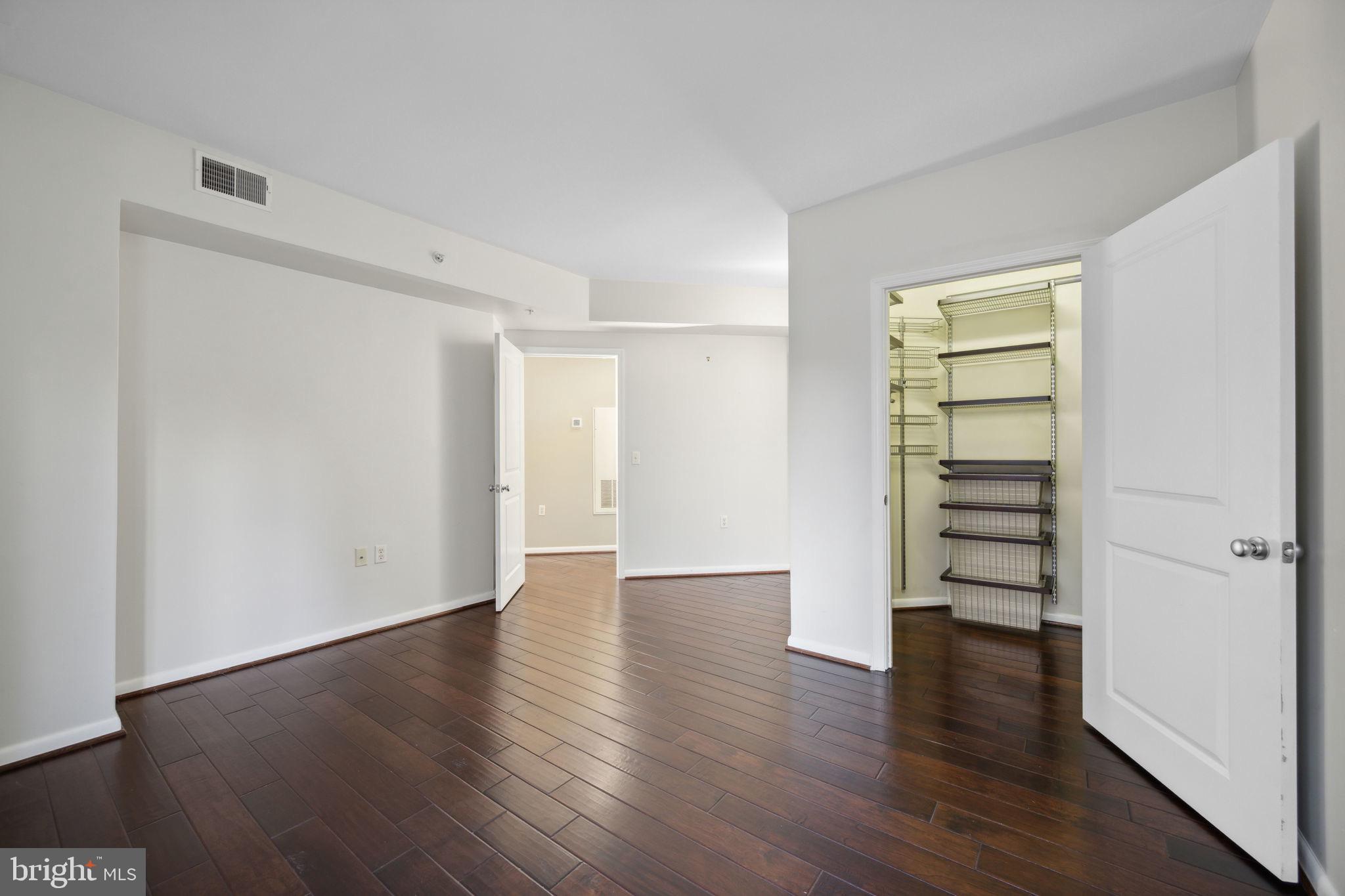 851 North Glebe Road, Unit 604 Arlington, VA 22203 - Photo 8 of 58 an empty room with wooden floor cabinets and windows