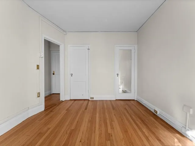 a view of a room with wooden floor