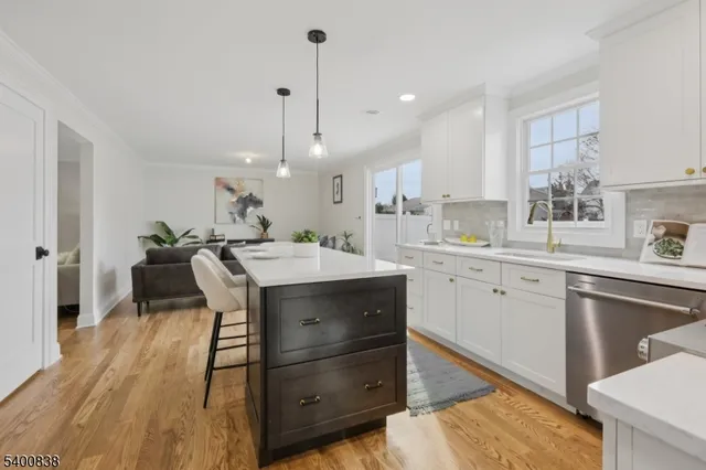 a kitchen with a sink a counter space appliances and cabinets
