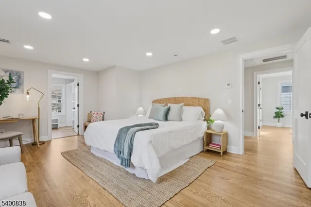 a spacious bedroom with a bed and a couch