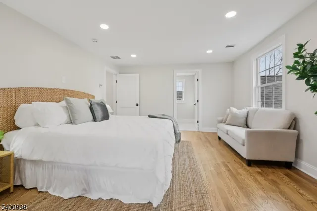 a spacious bedroom with a bed and a couch