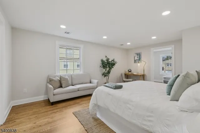 a spacious bedroom with a bed a couch and a couch