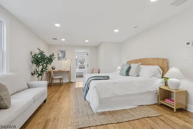 a spacious bedroom with a bed and a couch