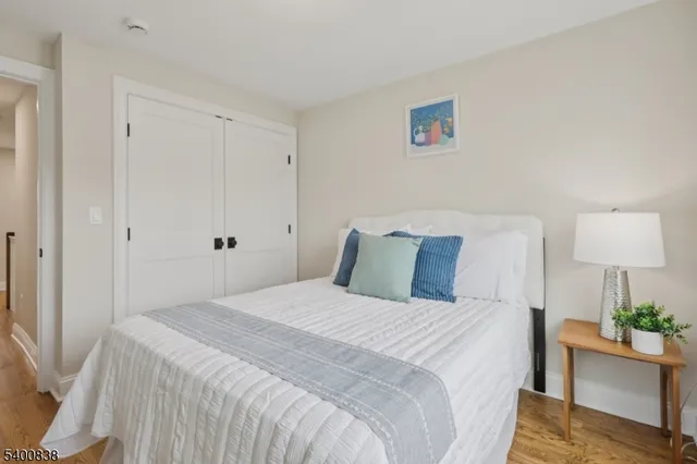 a bedroom with a bed table and a window