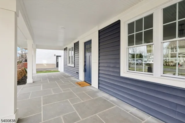 a view of an entryway with wooden floor and door