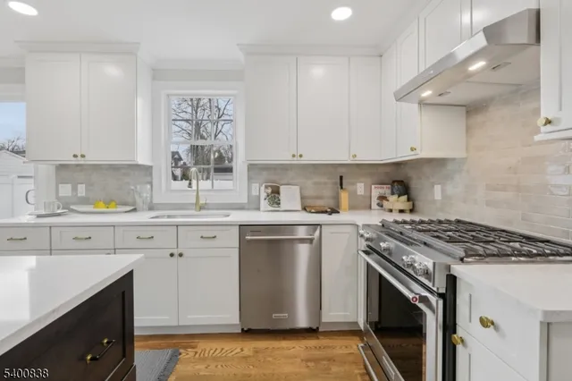 a kitchen with cabinets appliances and a window