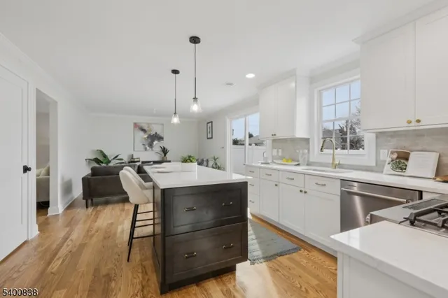 a kitchen with a table chairs sink and cabinets