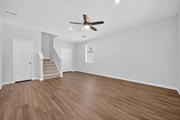 wooden floor in an empty room with a window