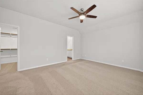 an empty room with closet and windows