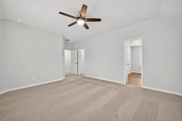 a view of an empty room with a ceiling fan