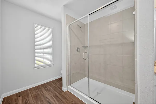 a bathroom with a glass shower door