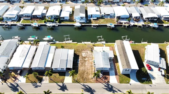 a view of a lake with boats and large trees