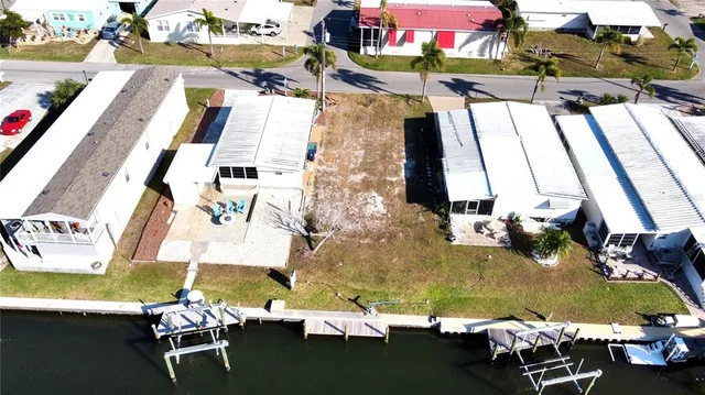an aerial view of a swimming pool with outdoor seating