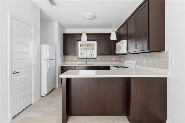 a kitchen with stainless steel appliances a sink stove and cabinets