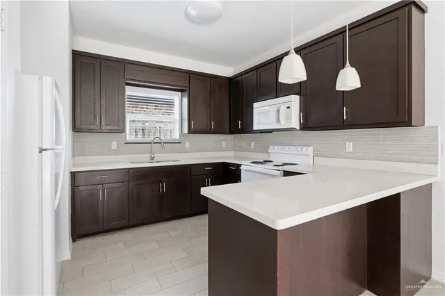a kitchen with a sink cabinets and window