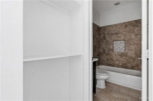 a bathroom with a toilet and a shower