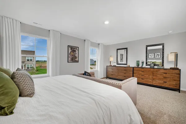 a bedroom with a large bed and a couch