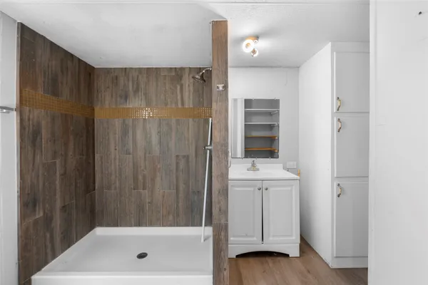 a bathroom with a shower and a sink