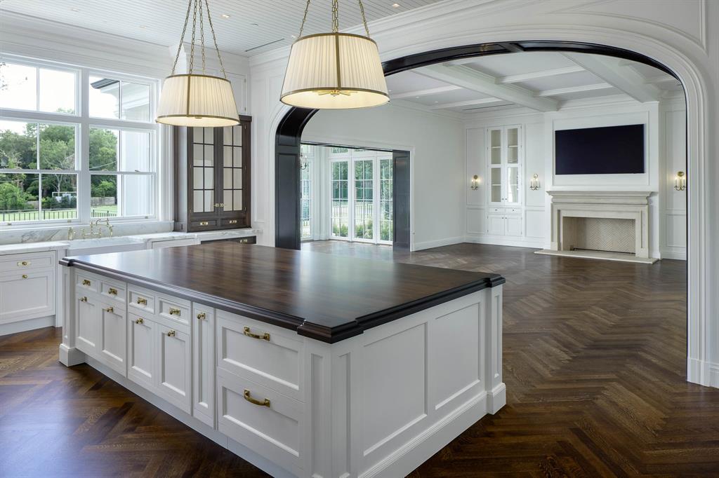 4606 Park Lane Dallas, TX 75220 - Photo 11 of 40 a kitchen with stainless steel appliances granite countertop a sink a microwave oven and a dining table with wooden floor