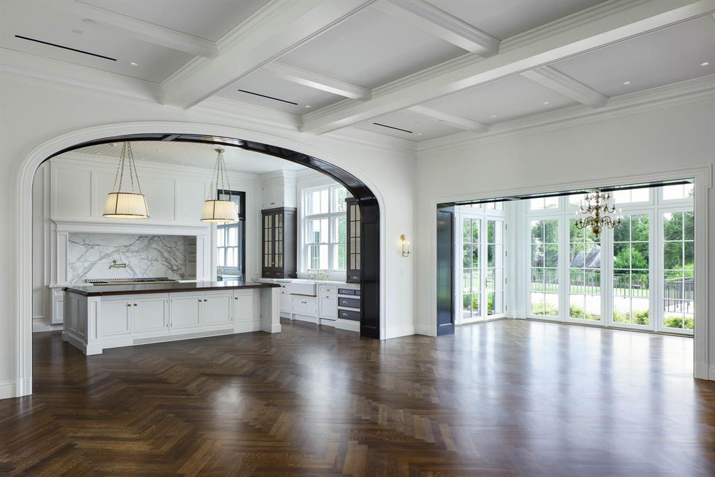 4606 Park Lane Dallas, TX 75220 - Photo 17 of 40 an empty room with wooden floor a kitchen view and a fireplace