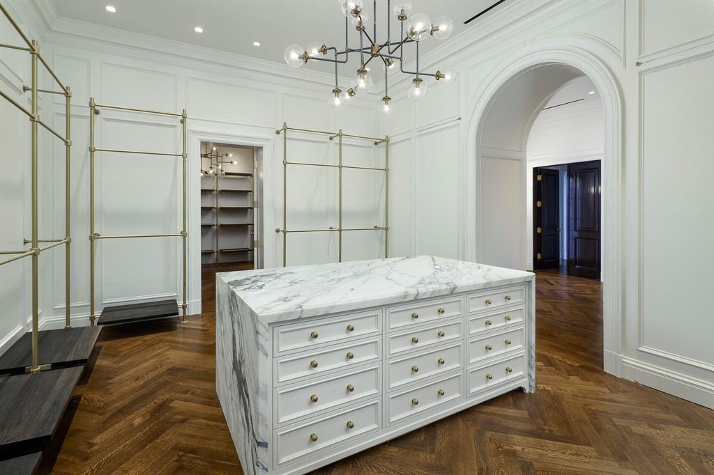 4606 Park Lane Dallas, TX 75220 - Photo 30 of 40 a room with a dresser and chandelier