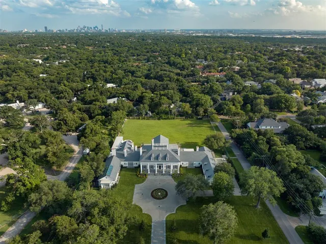 a aerial view of a house with swimming pool and a yard