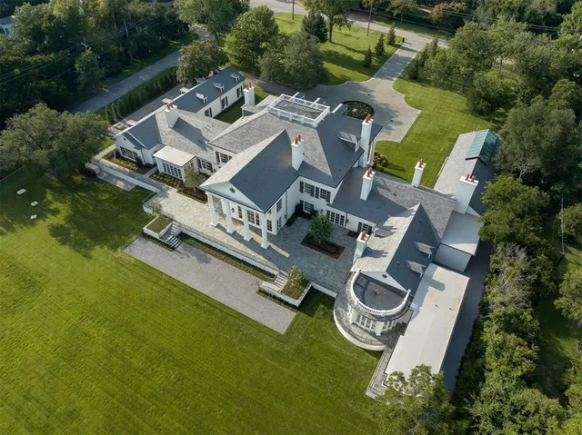 an aerial view of a house with garden space and car parked