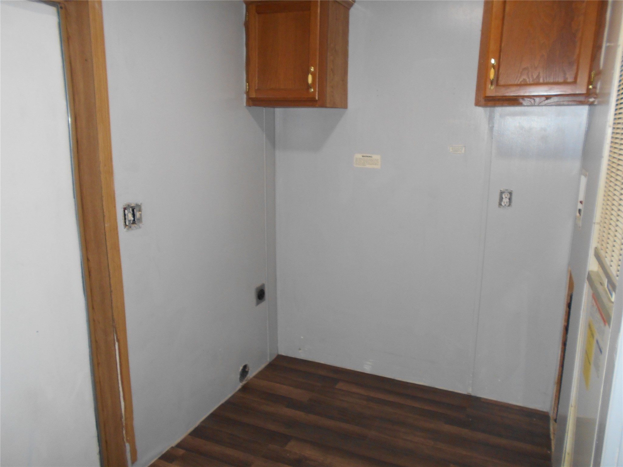 8001 Burleson Manor Road Manor, TX 78653 - Photo 16 of 31 Functional utility space with durable wood-look flooring and convenient wall-mounted cabinetry.