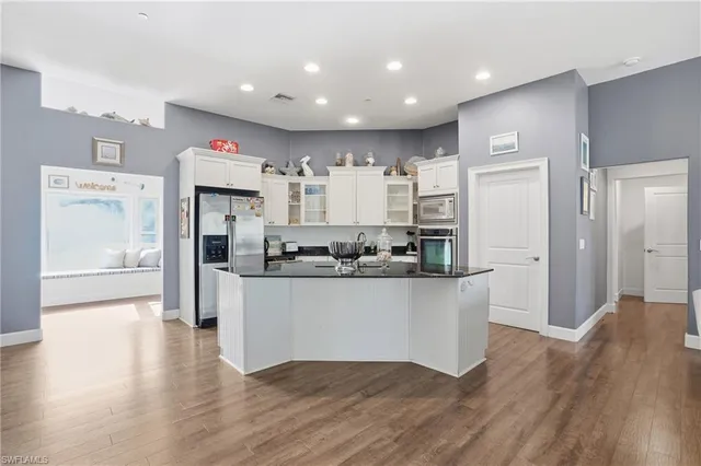 a kitchen with stainless steel appliances granite countertop a refrigerator and a sink