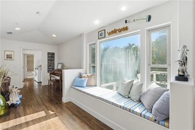 a living room with furniture and a floor to ceiling window