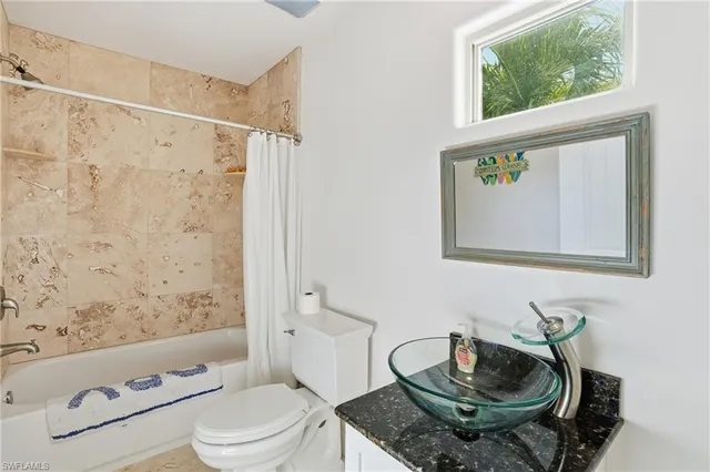 a bedroom with a bed couch and window