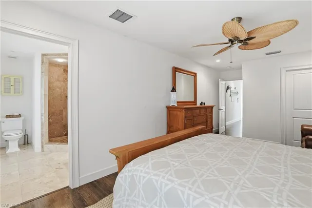 a bathroom with a toilet sink shower and mirror