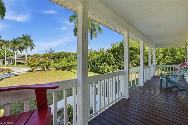 a view of a balcony with chair and wooden floor